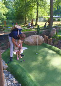 Dad and child playing Adventure Golf at Hexengolf